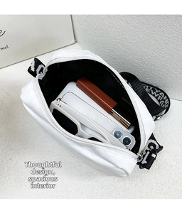 Internal view of white nylon shoulder bag showing phone, sunglasses and lipstick storage