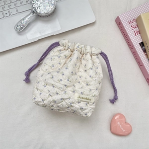 Close-up of quilted floral drawstring storage bag with purple flower pattern