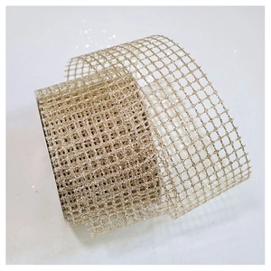 Detail of golden glitter mesh ribbon roll for Christmas tree decor and gift wrapping