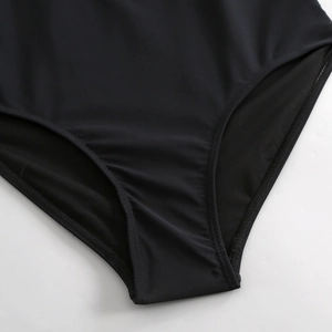Detail of black high-cut swimsuit bottoms with smooth texture and seamless stitching