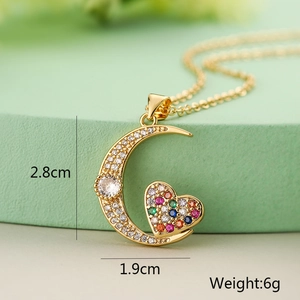 Detail shot of moon and heart pendant in gold finish with sparkling zircons and size labels