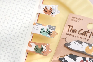 Detailed view of cat-shaped paper index tabs used for categorizing school notebook pages