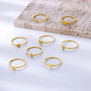 Set of eight gold adjustable open rings featuring sun, moon, and star symbols on stone decor