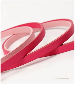 Detailed macro view showing the soft lychee grain texture of the pink leather waist belt