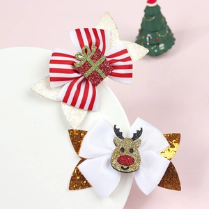 Detail of Christmas glitter hair clips featuring reindeer and gift box bow designs