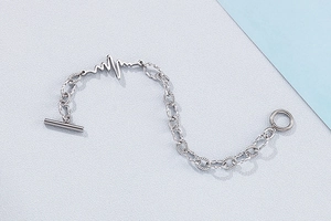 Detail of lifeline pulse wave charm and textured twisted chain with OT toggle clasp