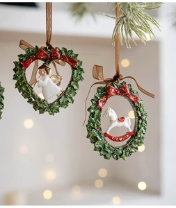 Detail of vintage Christmas resin ornaments with angel and rocking horse in wreaths
