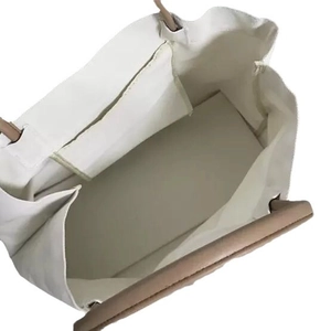 Minimalist white canvas tote bag with large capacity and khaki handles shown from top view