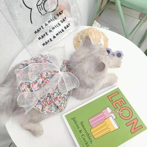 Close-up of a floral pet dress for dogs and cats featuring a large white mesh bow detail