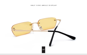 Detail shot of yellow rimless rectangle sunglasses with gold metal frame from 180 side view