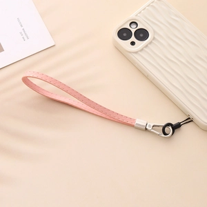Pink PU leather phone wrist strap with silver metal buckle on minimalist background