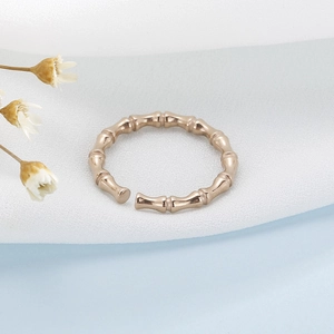 Macro shot of rose gold bamboo joint open ring with adjustable minimalist texture