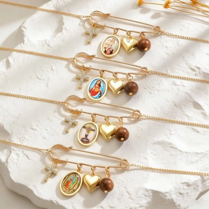 Vintage gold safety pin necklace with cross, religious medals, heart and wooden bead charms