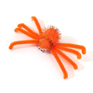 Macro view of bright orange fuzzy spider hair clip for Halloween costume accessories