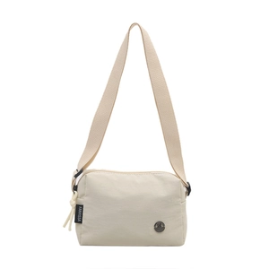 Chic beige canvas crossbody bag with adjustable wide strap and vintage metal logo
