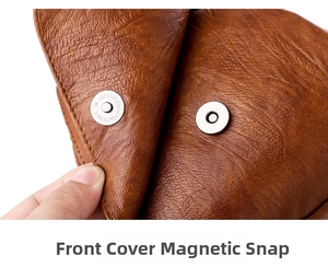 Close-up of the metal magnetic snap closure on textured brown leather bag flap