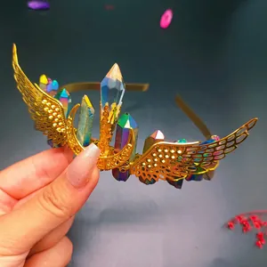 Macro detail of rainbow crystal headband with gold wings and crescent moon charm