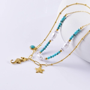 Double-layered turquoise and pearl necklace with golden seahorse and starfish charms