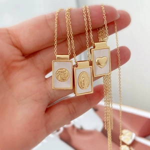 Gold rectangular necklaces with Virgin Mary, heart and FE engraving on white shell base