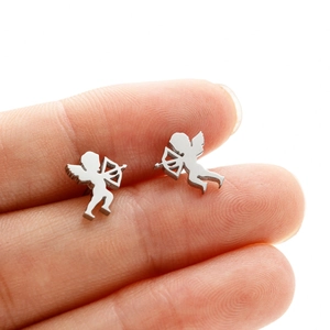 Detailed view of silver Cupid angel stud earrings shown on fingertip for size reference