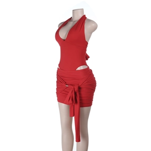 Side view of red backless halter top and ruched mini skirt with side tie details