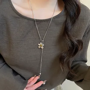 Silver Y-shaped tiger eye stone flower pendant necklace on a minimalist long snake chain