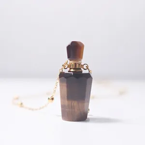 Tiger eye stone perfume bottle pendant with golden bead chain on white background