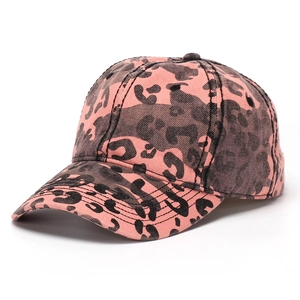 Macro detail of pink leopard print cotton baseball cap with twill fabric texture