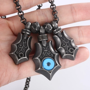 Vintage punk necklace featuring silver shield pendants with blue evil eye on metal chain