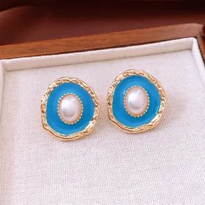 Vintage gold oval pearl earrings with sky blue enamel finish for a luxury retro style