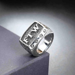 Macro shot of men's FTW signet ring in vintage stainless steel with industrial screw details