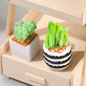 Miniature artificial cactus and succulent plants set in small pots on a wooden stand