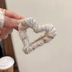 Close-up of mixed color heart plush hair claw clip with wool wrap texture