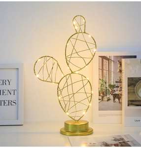 Golden iron cactus LED night light with warm white wire bulbs in a home setting