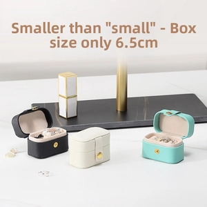 Mini travel jewelry box in PU leather with 6.5cm length showing ring slots and snap closure