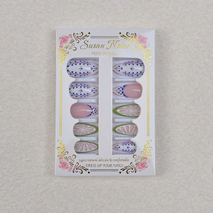 Detail of 24pcs almond press-on nails featuring blue geometric and green floral patterns