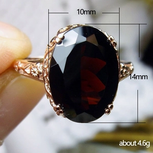 Vintage rose gold ring with a large oval red zircon and intricate floral engraving