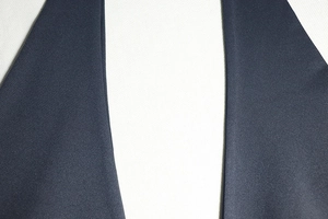 Close-up of the high-quality fine knit fabric texture on this backless sleeveless jumpsuit