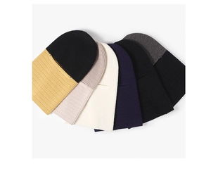 Detail showing various colors of ribbed knit balaclavas with eye cutouts for winter