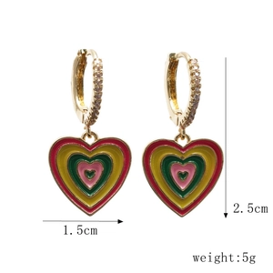 Detail view of heart-shaped enamel earrings with gold plating and size measurements