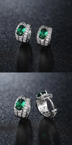 Macro view of emerald green crystal drop earrings with silver pave setting