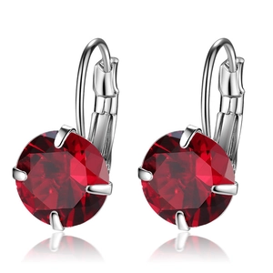 Detailed view of silver hoop earrings with round-cut red ruby-colored crystals in four-prong setting