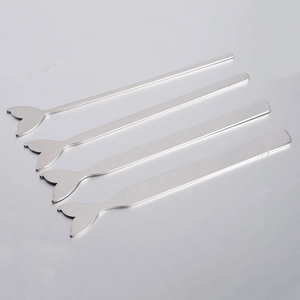 Detailed set of four silver stainless steel makeup spatulas with whale tail handles