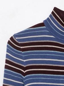 Detailed view of the soft knit texture and striped high neck design in retro colors