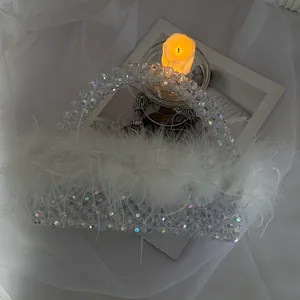 Detailed close-up of a white ostrich feather beaded handbag for evening parties