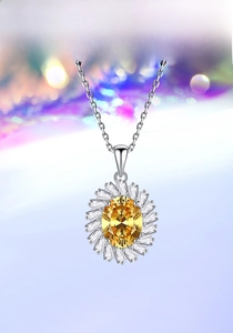 Detailed close-up of a silver sunflower pendant with a yellow oval gemstone center