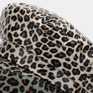Macro detail of leopard print PU leather beret showing premium stitching and texture