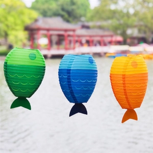 Hanging colorful fish-shaped paper lanterns in blue, green and orange for party decor