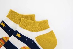 Close-up of astronaut themed cotton socks featuring planet patterns and stars details