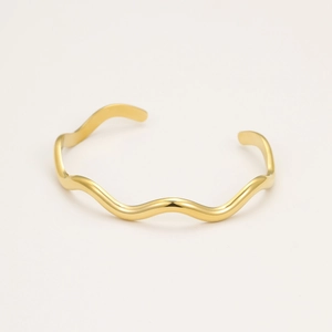 Minimalist gold wavy open bangle with polished metallic finish and geometric curve design